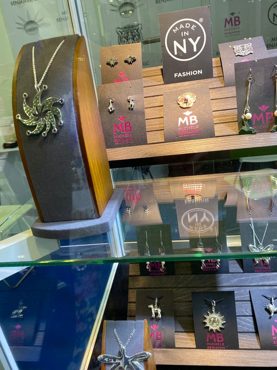Michele Benjamin -Jewelry Design display showing collections of Sterling silver jewelry including Bees, Starburst Ruby Necklace, 
